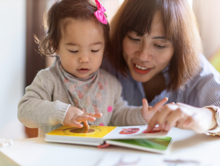 Mom reading to toddler girl