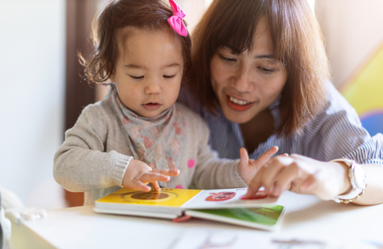 Mom reading to toddler girl